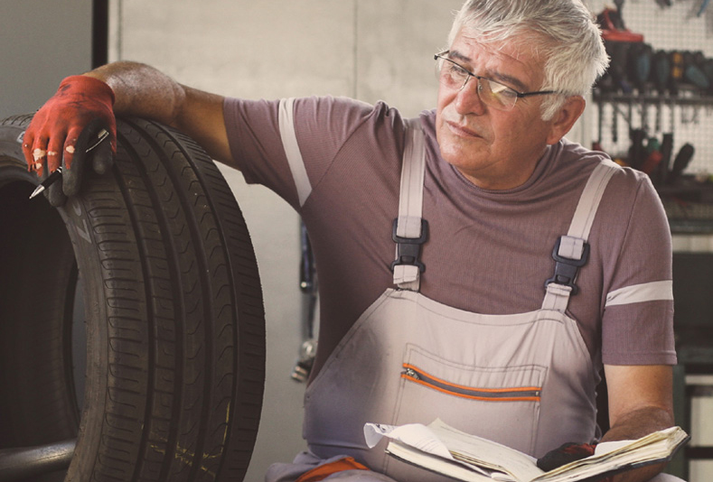 Older man working in Garage Shop